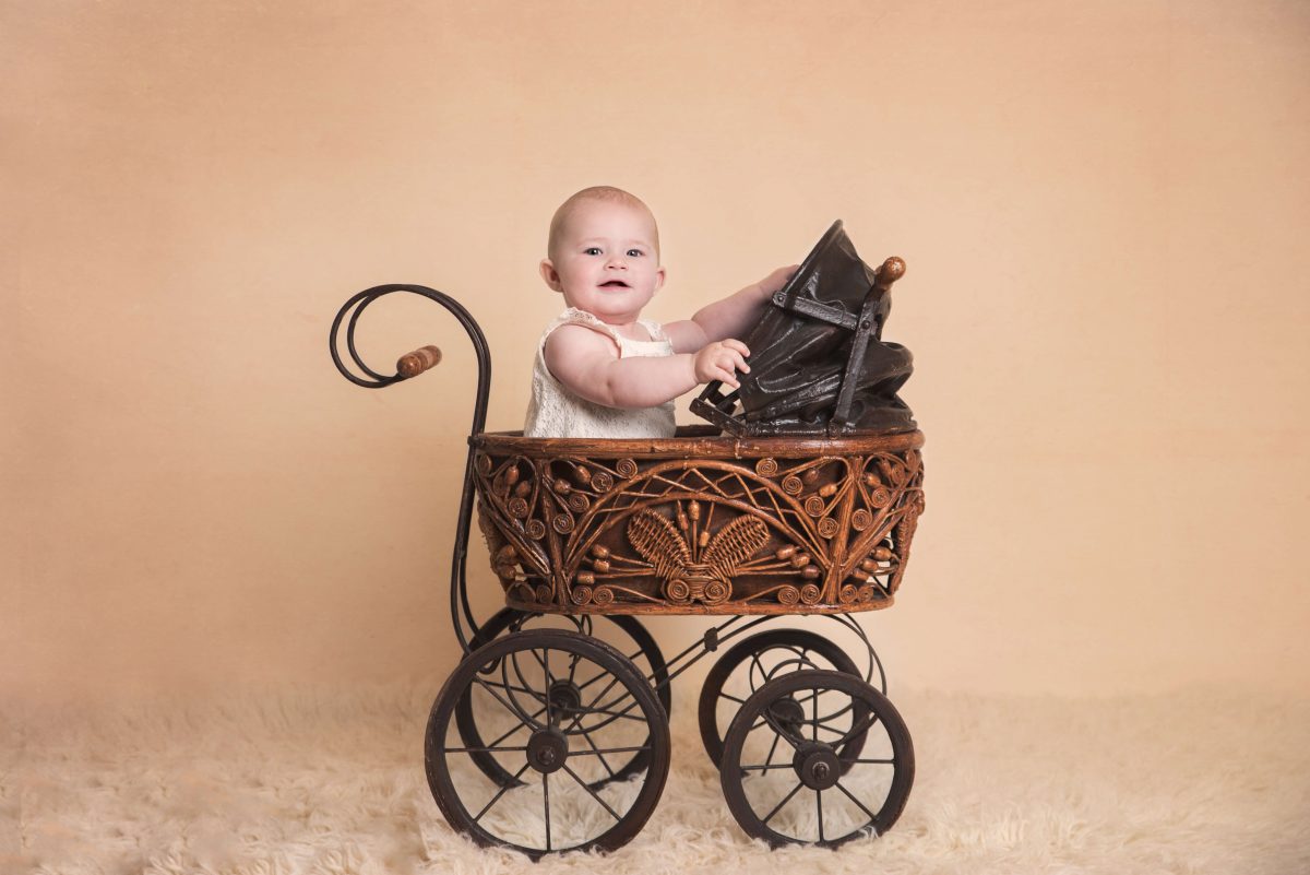 Slice of Life Little Sitters Session Gallery - baby girl sat in a hanging pink floral arrangement