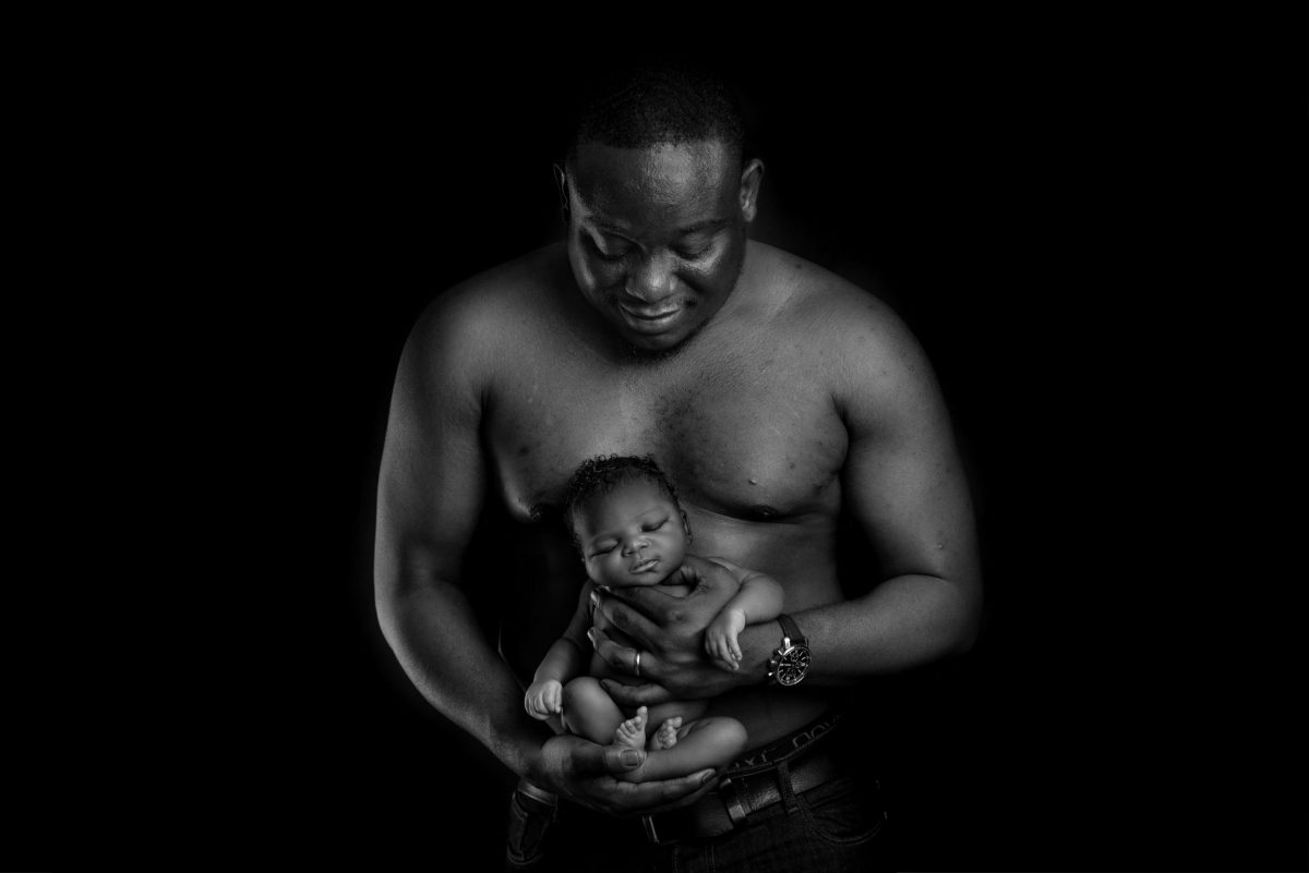 Black and white photo of baby and her daddy during newborn photoshoot